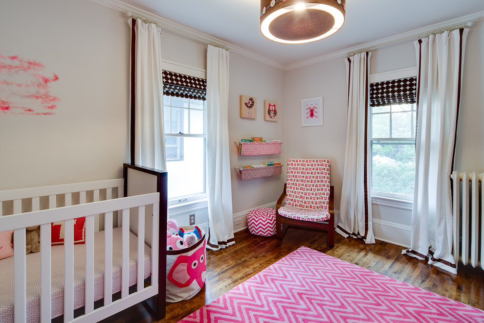 Transitional Nursery - Transitional girl dark wood floor nursery photo in Minneapolis with beige walls