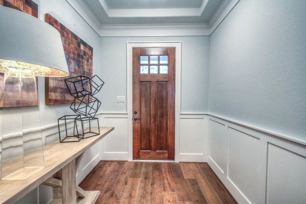 Mid-sized transitional medium tone wood floor foyer photo in Houston with gray walls and a medium wood front door