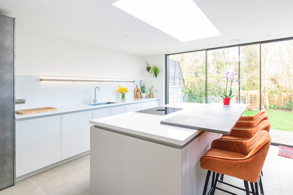 Mid-sized contemporary single-wall open plan kitchen in Sussex with with island.