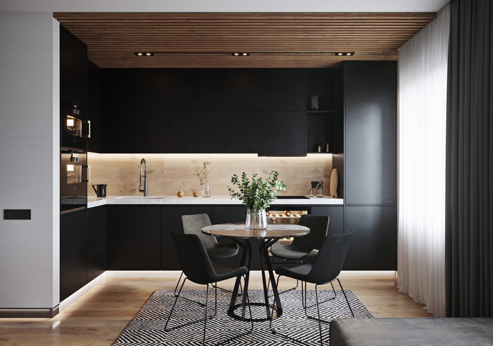 Photo of a small contemporary l-shaped eat-in kitchen in Valencia with an integrated sink, flat-panel cabinets, black cabinets, marble benchtops, beige splashback, porcelain splashback, black appliances, porcelain floors, beige floor, white benchtop and no island.