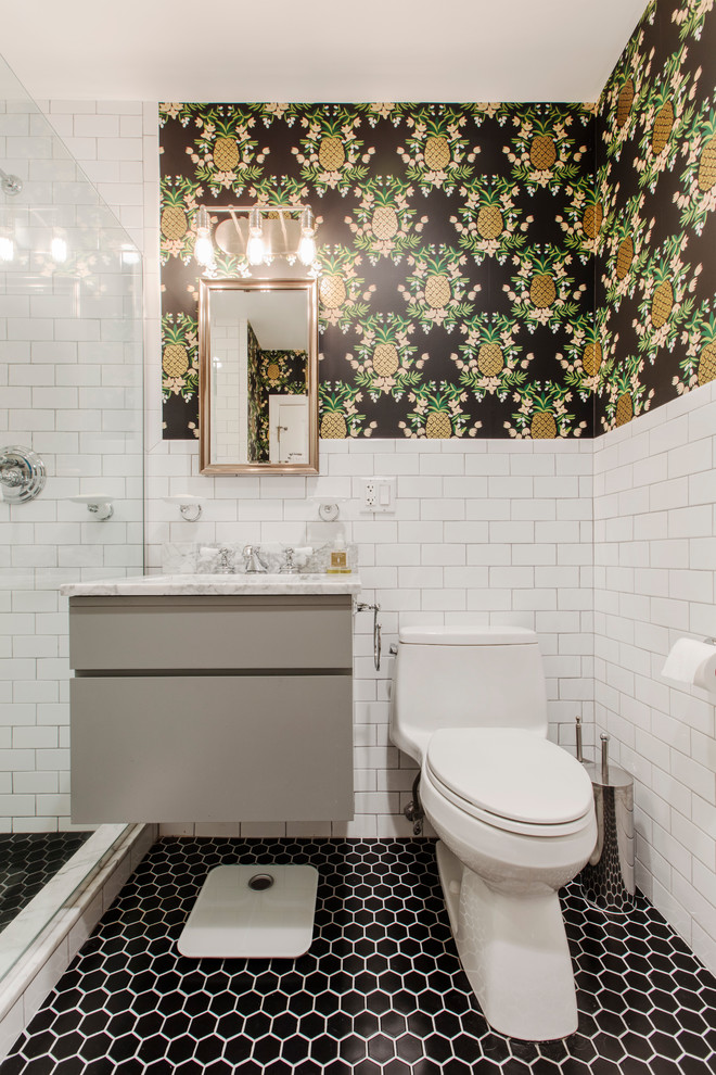 This is an example of a mid-sized contemporary 3/4 bathroom in New York with flat-panel cabinets, beige cabinets, an alcove shower, a one-piece toilet, white tile, subway tile, multi-coloured walls and a hinged shower door.