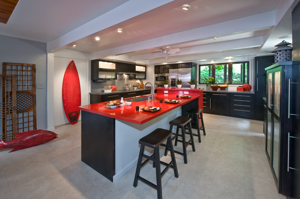 This is an example of a large contemporary u-shaped eat-in kitchen in Hawaii with a single-bowl sink, flat-panel cabinets, dark wood cabinets, grey splashback, stainless steel appliances, ceramic floors, with island, quartz benchtops, stone slab splashback and beige floor.