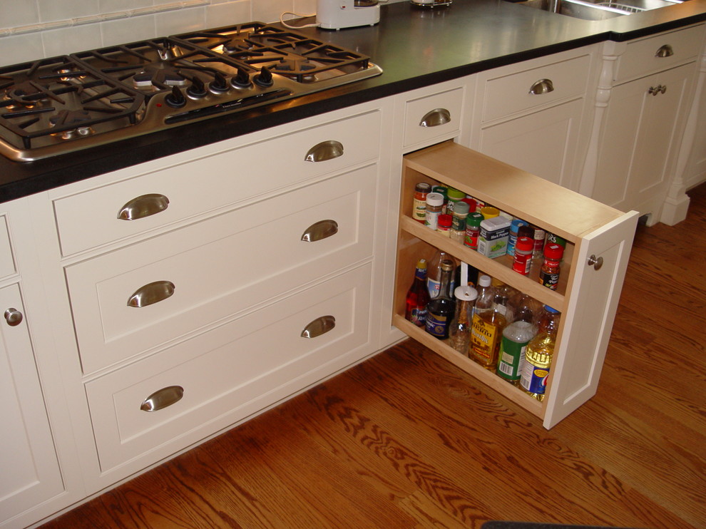 Transitional medium tone wood floor eat-in kitchen photo in Boston with an undermount sink, beaded inset cabinets, white cabinets, granite countertops, white backsplash, subway tile backsplash, paneled appliances, yellow walls and an island