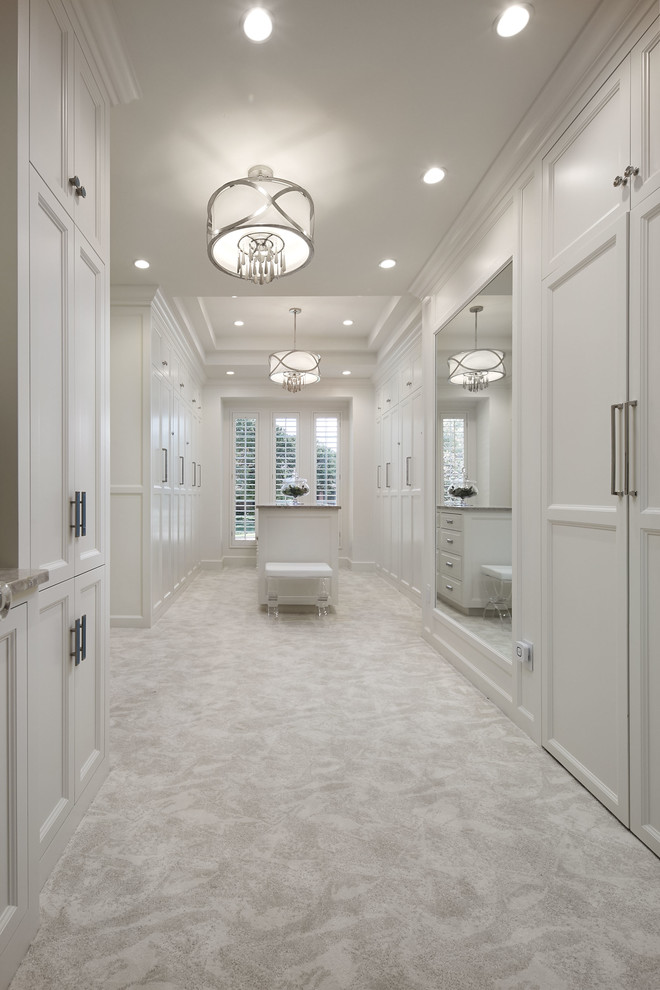 Inspiration for a large transitional gender-neutral walk-in wardrobe in Oklahoma City with shaker cabinets, white cabinets, carpet and white floor.
