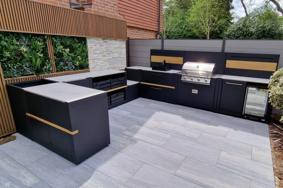 Design ideas for a mid-sized contemporary backyard patio in Other with an outdoor kitchen, tile and no cover.