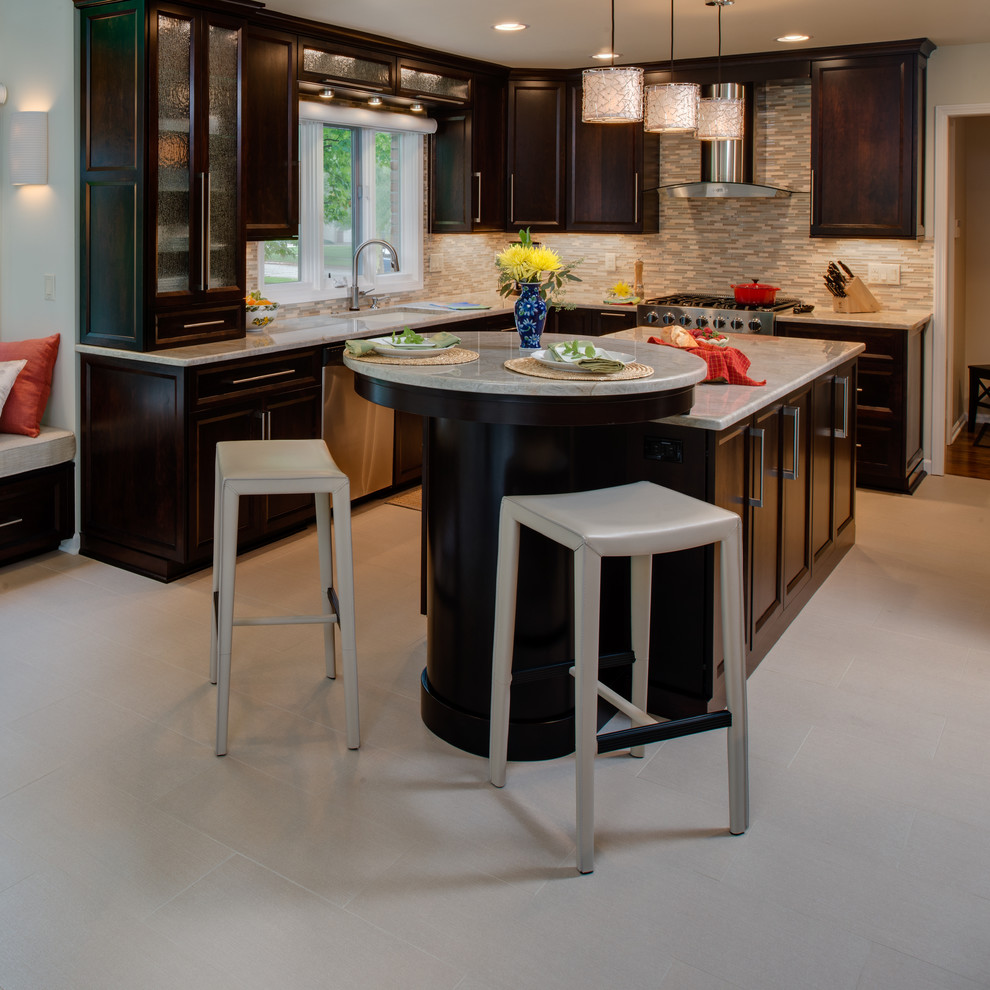 Mid-sized modern l-shaped eat-in kitchen in Detroit with an undermount sink, recessed-panel cabinets, dark wood cabinets, quartzite benchtops, green splashback, mosaic tile splashback, stainless steel appliances, ceramic floors and with island.