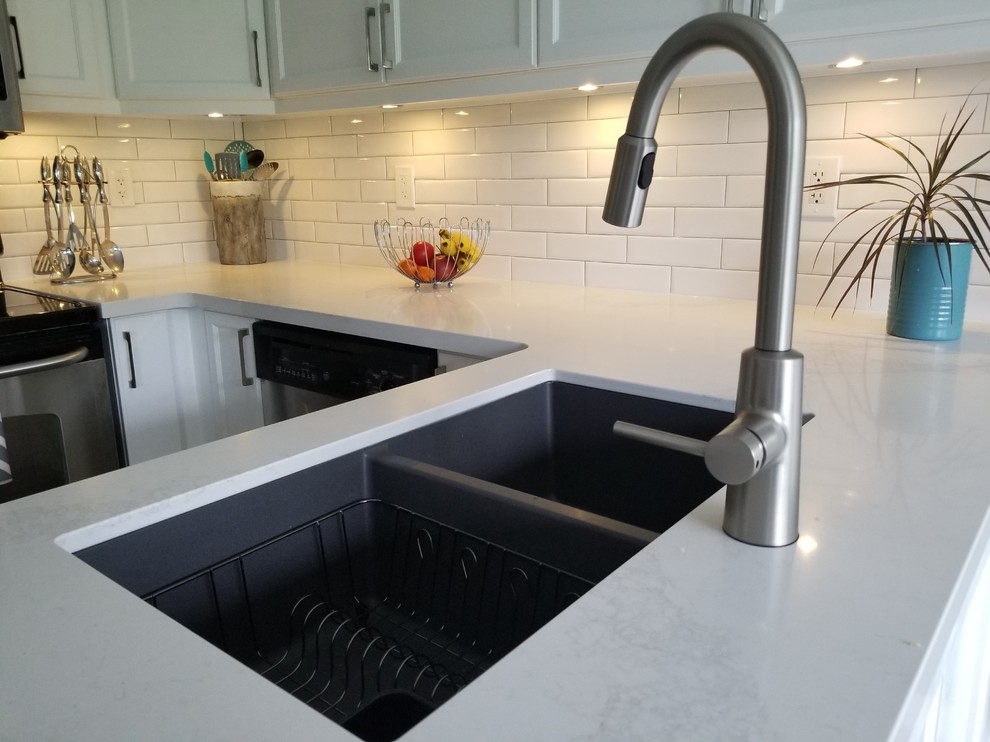 Eat-in kitchen - small transitional u-shaped porcelain tile and beige floor eat-in kitchen idea in Toronto with a double-bowl sink, recessed-panel cabinets, white cabinets, quartz countertops, white backsplash, subway tile backsplash, stainless steel appliances, a peninsula and white countertops