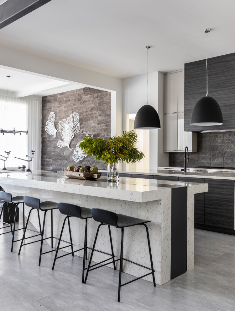 Design ideas for a contemporary kitchen in Houston with flat-panel cabinets, black splashback, with island, grey floor and multi-coloured benchtop.