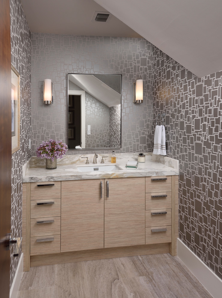 Inspiration for a transitional medium tone wood floor powder room remodel in Miami with an undermount sink, flat-panel cabinets, light wood cabinets, gray walls and gray countertops