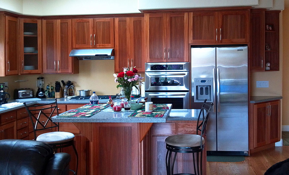 Inspiration for a brown floor kitchen remodel with an integrated sink, shaker cabinets, stainless steel appliances and an island