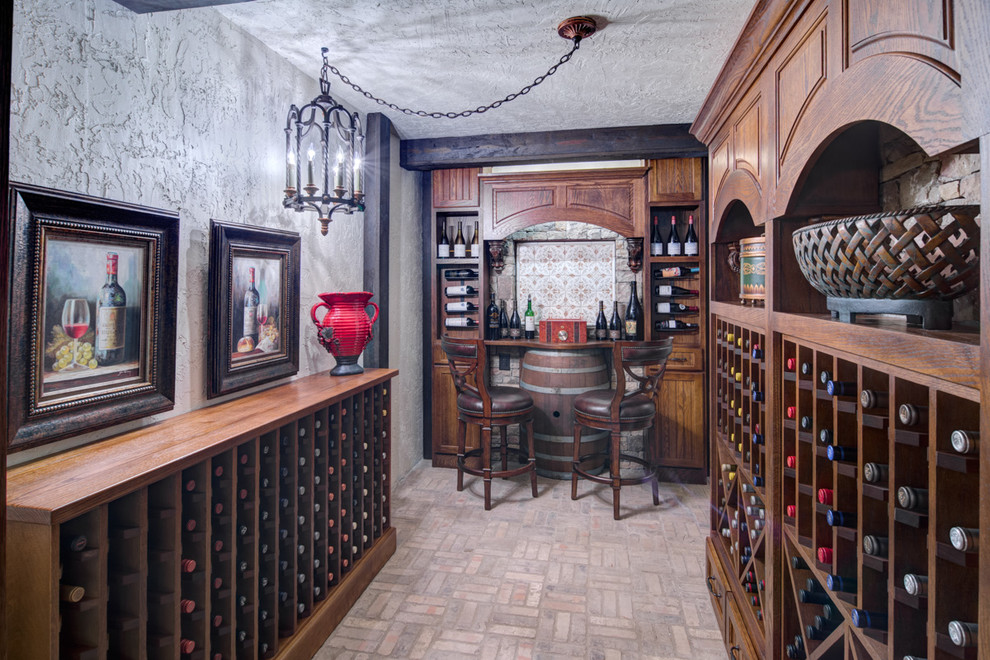 This is an example of a mid-sized traditional wine cellar in Atlanta with brick floors, display racks and grey floor.