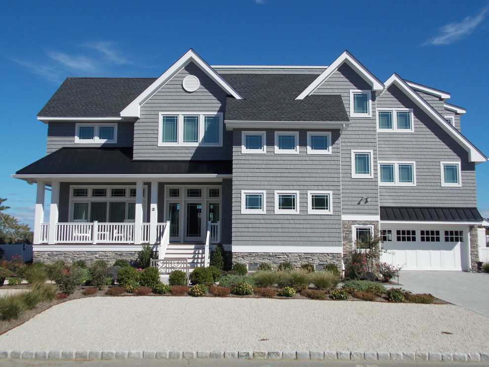 Design ideas for a beach style grey exterior in New York with vinyl siding and a gable roof.