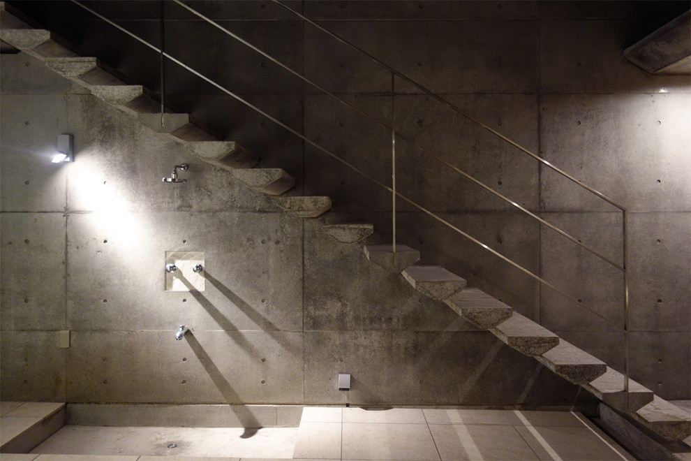 Industrial concrete floating staircase in Tokyo Suburbs with open risers.