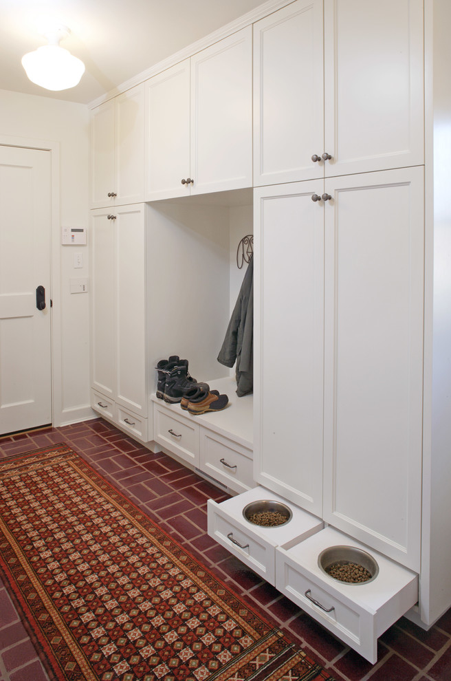 Traditional mudroom in Omaha with white walls, a single front door, a white front door and red floor.