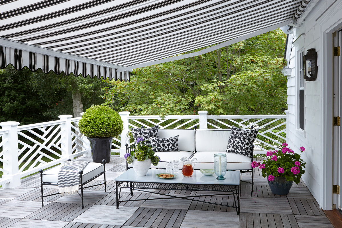 Design ideas for a traditional verandah in New York with decking and an awning.