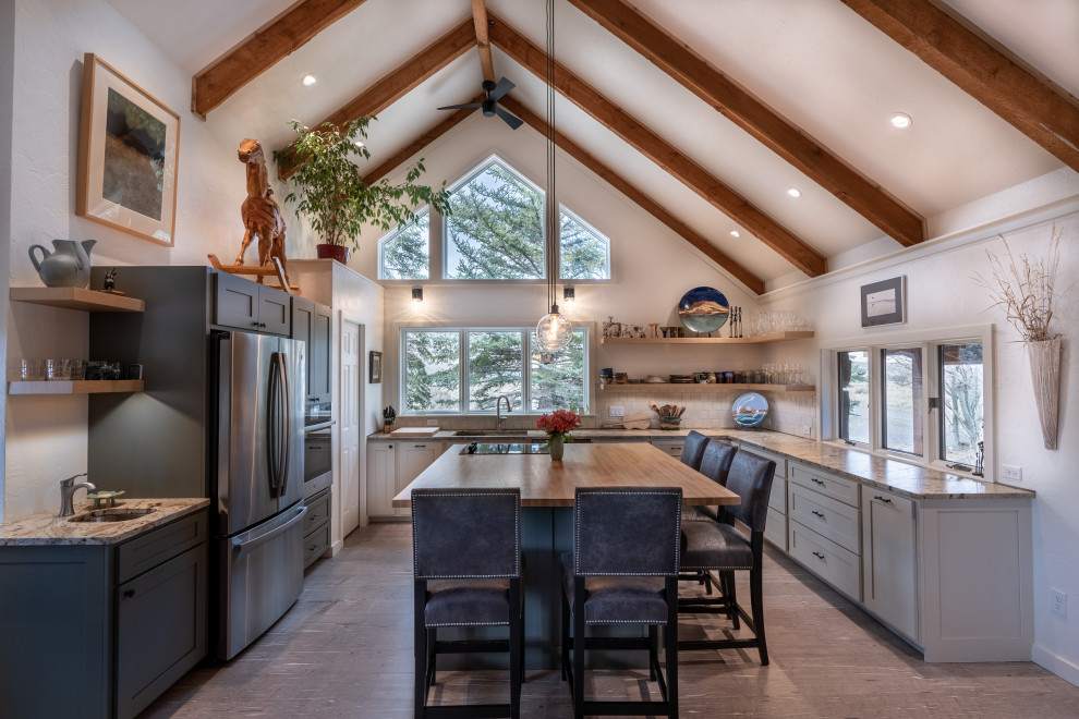 Example of a mid-sized transitional u-shaped vaulted ceiling eat-in kitchen design with shaker cabinets, green cabinets, granite countertops, beige backsplash, ceramic backsplash, stainless steel appliances, an island and multicolored countertops