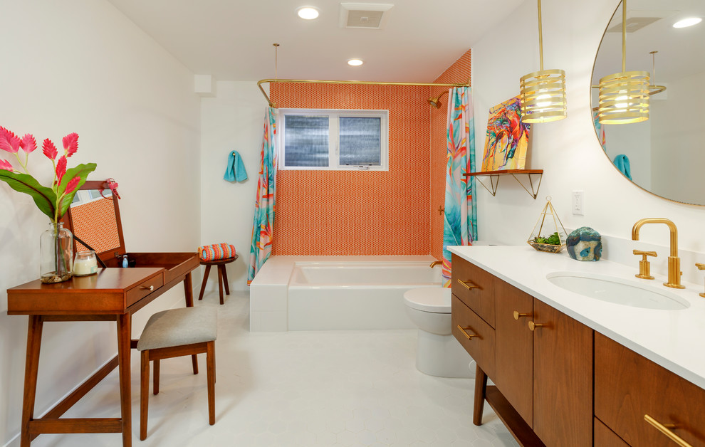 Photo of a midcentury bathroom in Los Angeles with flat-panel cabinets, medium wood cabinets, a corner tub, a shower/bathtub combo, orange tile, white walls, an undermount sink, yellow floor and a shower curtain.