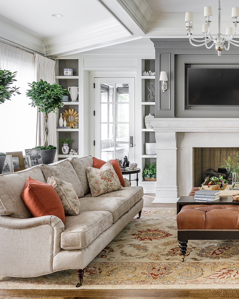 Living room - large transitional medium tone wood floor and brown floor living room idea in Chicago with gray walls, a wall-mounted tv and a standard fireplace