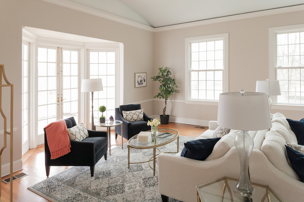 Design ideas for a mid-sized transitional formal enclosed living room in Bridgeport with white walls and light hardwood floors.