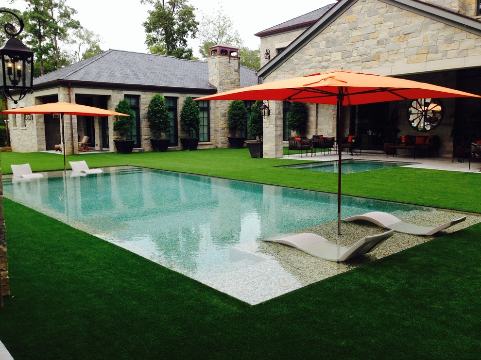 Photo of a mid-sized tropical backyard rectangular lap pool in Houston with a hot tub.