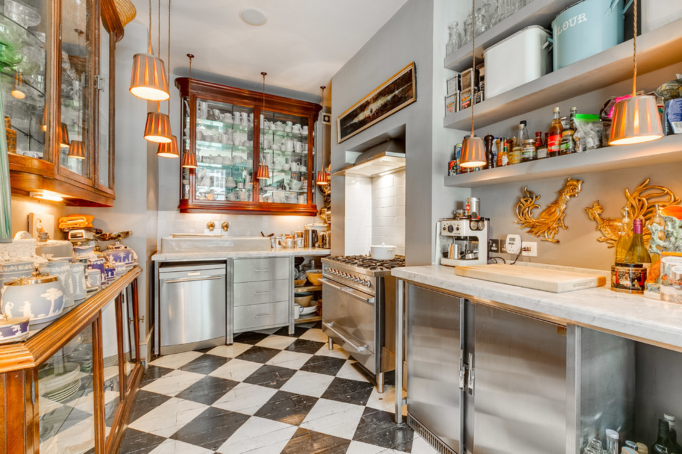This is an example of a mid-sized eclectic u-shaped kitchen in London with glass-front cabinets, dark wood cabinets, white splashback, stainless steel appliances, painted wood floors, no island and multi-coloured floor.