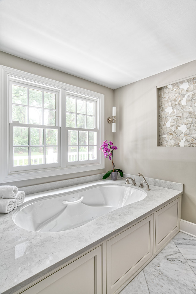 Design ideas for a large traditional master bathroom in New York with beaded inset cabinets, an undermount tub, a corner shower, white tile, mosaic tile, marble floors, an undermount sink, quartzite benchtops, white floor, a hinged shower door and white benchtops.