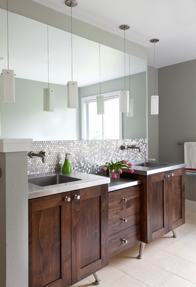 Design ideas for a contemporary master bathroom in Denver with an integrated sink, shaker cabinets, dark wood cabinets, stainless steel benchtops, metal tile, grey walls and porcelain floors.