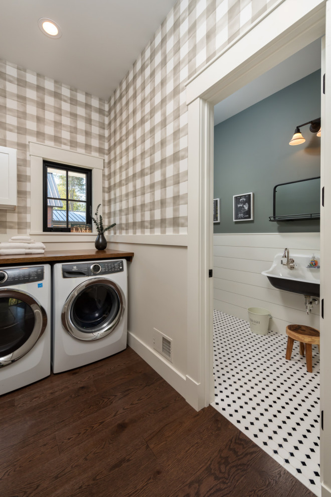 This is an example of a mid-sized transitional single-wall dedicated laundry room in Boston with wood benchtops, grey walls, medium hardwood floors, brown floor, brown benchtop and wallpaper.