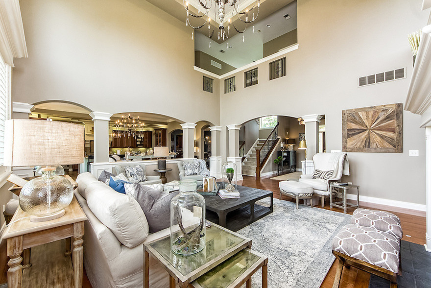 Inspiration for a mid-sized transitional open concept medium tone wood floor living room remodel in Columbus with beige walls, a standard fireplace, a tile fireplace and a media wall