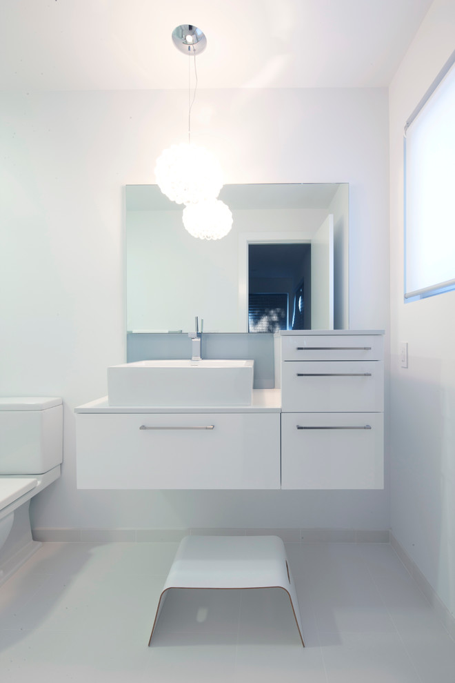Inspiration for a mid-sized contemporary kids' white tile ceramic tile bathroom remodel in San Francisco with a vessel sink, flat-panel cabinets, white cabinets, quartz countertops, a two-piece toilet and white walls
