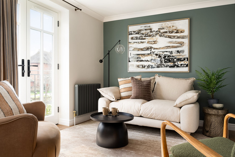 This is an example of a small eclectic enclosed living room in Wiltshire with green walls, vinyl flooring, a standard fireplace, a wooden fireplace surround, a wall mounted tv and beige floors.