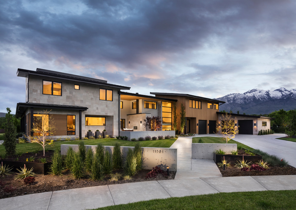 Design ideas for an expansive contemporary two-storey beige house exterior in Salt Lake City with mixed siding and a shed roof.