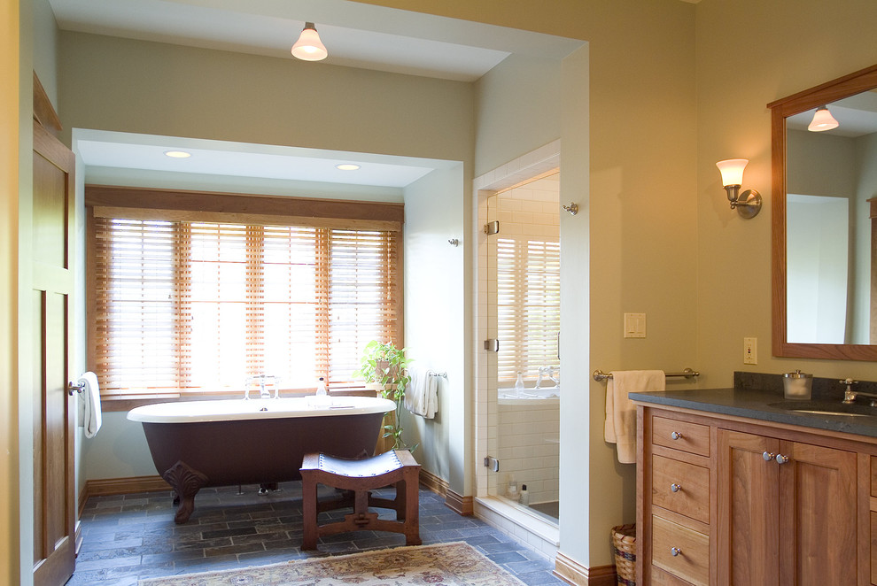 Photo of a traditional bathroom in Minneapolis with a claw-foot tub and slate floors.