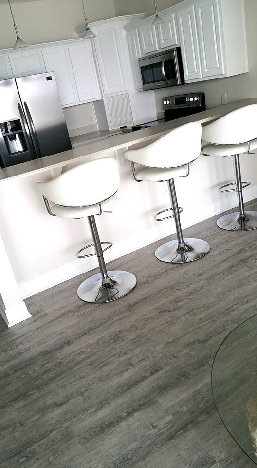 Eat-in kitchen - small transitional u-shaped medium tone wood floor eat-in kitchen idea with a drop-in sink, raised-panel cabinets, white cabinets, laminate countertops, stainless steel appliances and no island