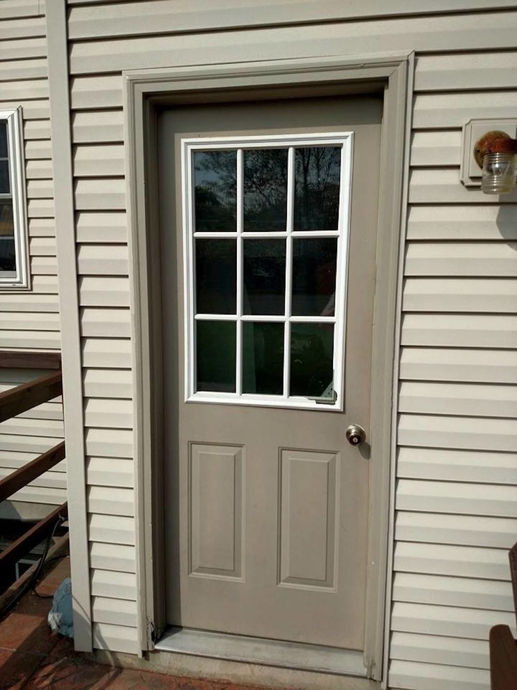 Small transitional front door photo with a brown front door