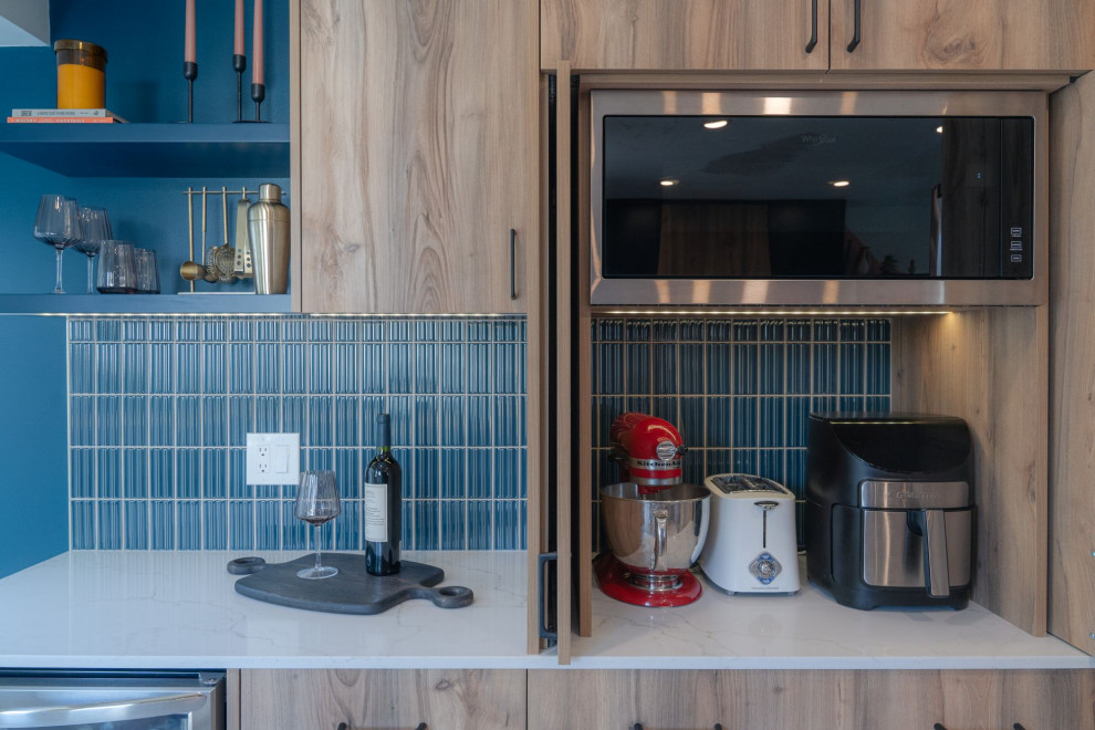 Example of a small transitional u-shaped terrazzo floor and white floor eat-in kitchen design in Vancouver with a farmhouse sink, flat-panel cabinets, light wood cabinets, quartz countertops, blue backsplash, porcelain backsplash, stainless steel appliances, an island and white countertops