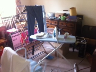Decluttered reception room used as a storage room