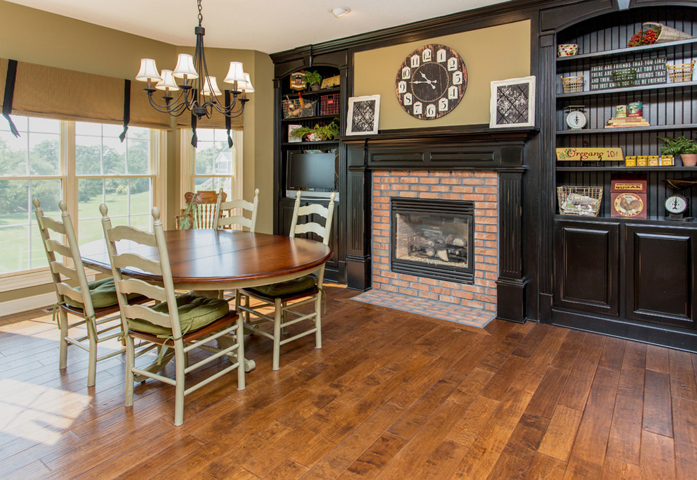 Example of a transitional medium tone wood floor kitchen design with black cabinets