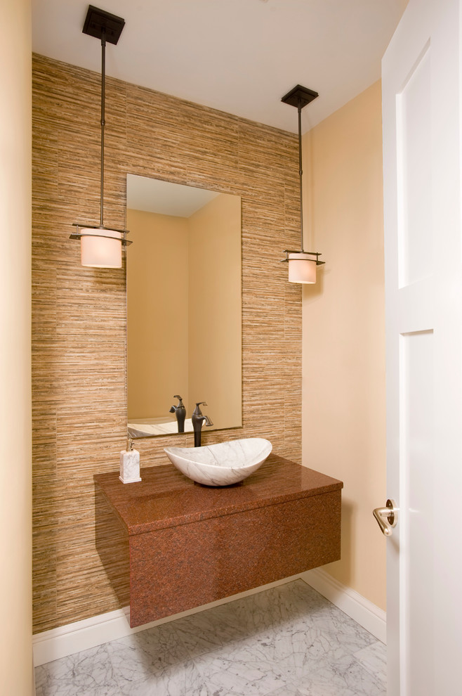This is an example of a contemporary powder room in Boston with a vessel sink and beige walls.