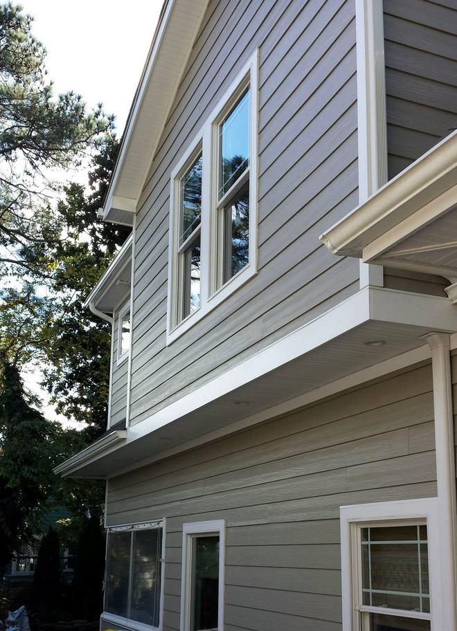 Photo of a mid-sized traditional two-storey brown exterior in Other with concrete fiberboard siding and a gambrel roof.