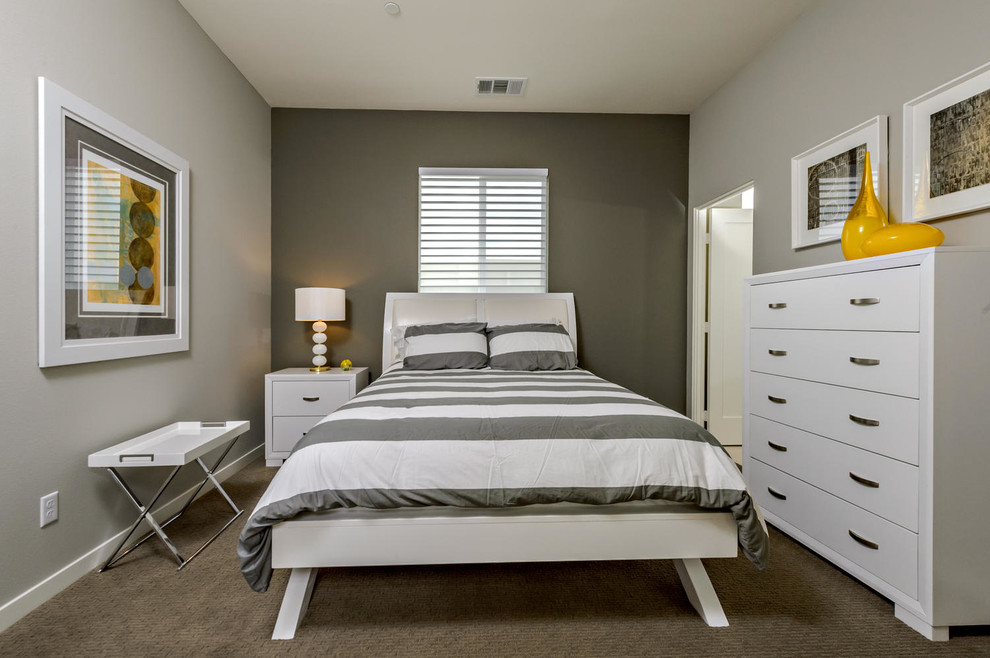 This is an example of a small transitional guest bedroom in Orange County with grey walls, carpet, no fireplace and grey floor.