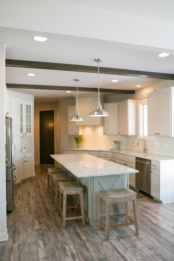 Open concept kitchen - mid-sized rustic l-shaped open concept kitchen idea with raised-panel cabinets, white cabinets, granite countertops, white backsplash, subway tile backsplash, stainless steel appliances, an island and gray countertops