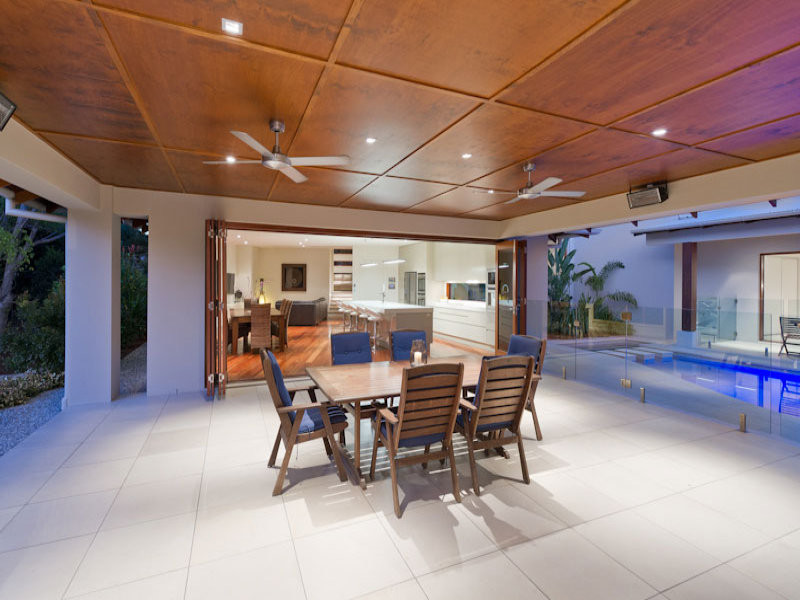 Inspiration for a mid-sized contemporary backyard patio in Brisbane with concrete pavers and a roof extension.