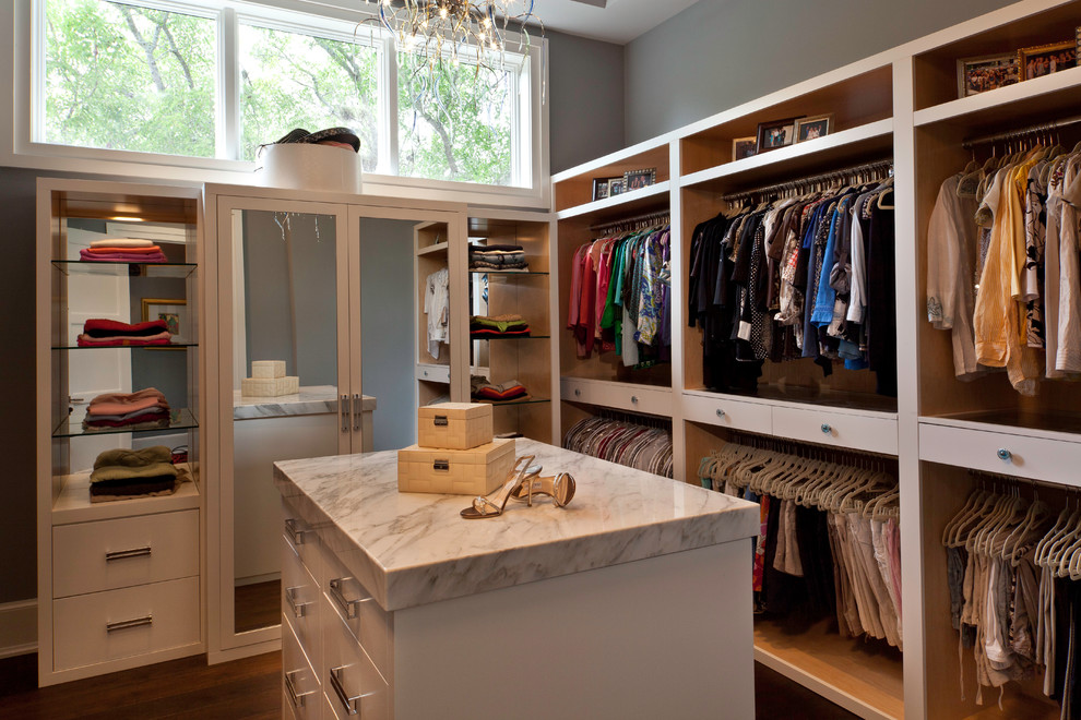 Inspiration for a contemporary women's dressing room in Miami with open cabinets and medium hardwood floors.
