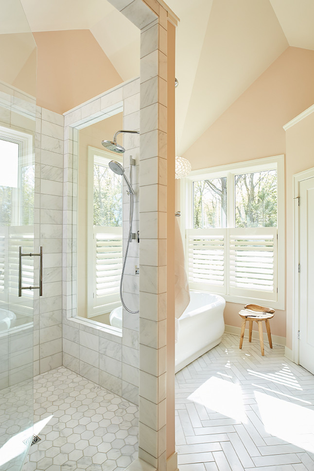 This is an example of a large midcentury master bathroom in Grand Rapids with flat-panel cabinets, brown cabinets, a freestanding tub, an alcove shower, a two-piece toilet, multi-coloured tile, matchstick tile, pink walls, marble floors, an undermount sink, engineered quartz benchtops, white floor, a hinged shower door and white benchtops.