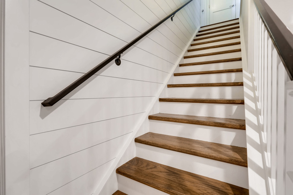 Mid-sized country staircase in Denver with planked wall panelling.