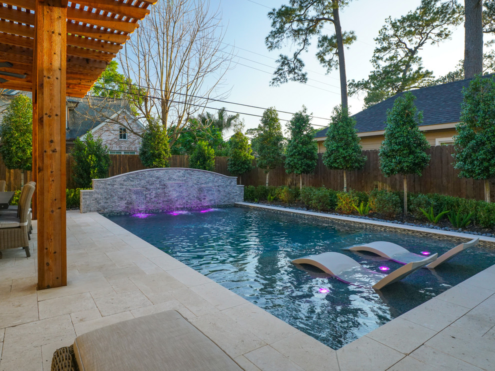 Photo of a small contemporary backyard rectangular natural pool in Houston with a water feature.