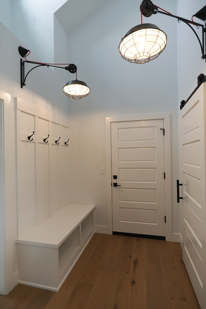 Mid-sized country mudroom in Portland with white walls, light hardwood floors, a single front door, a white front door and multi-coloured floor.