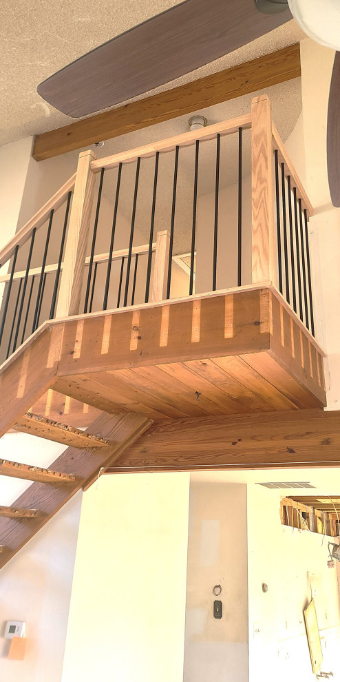 Photo of a mid-sized contemporary wood straight staircase in New York with wood risers and mixed railing.