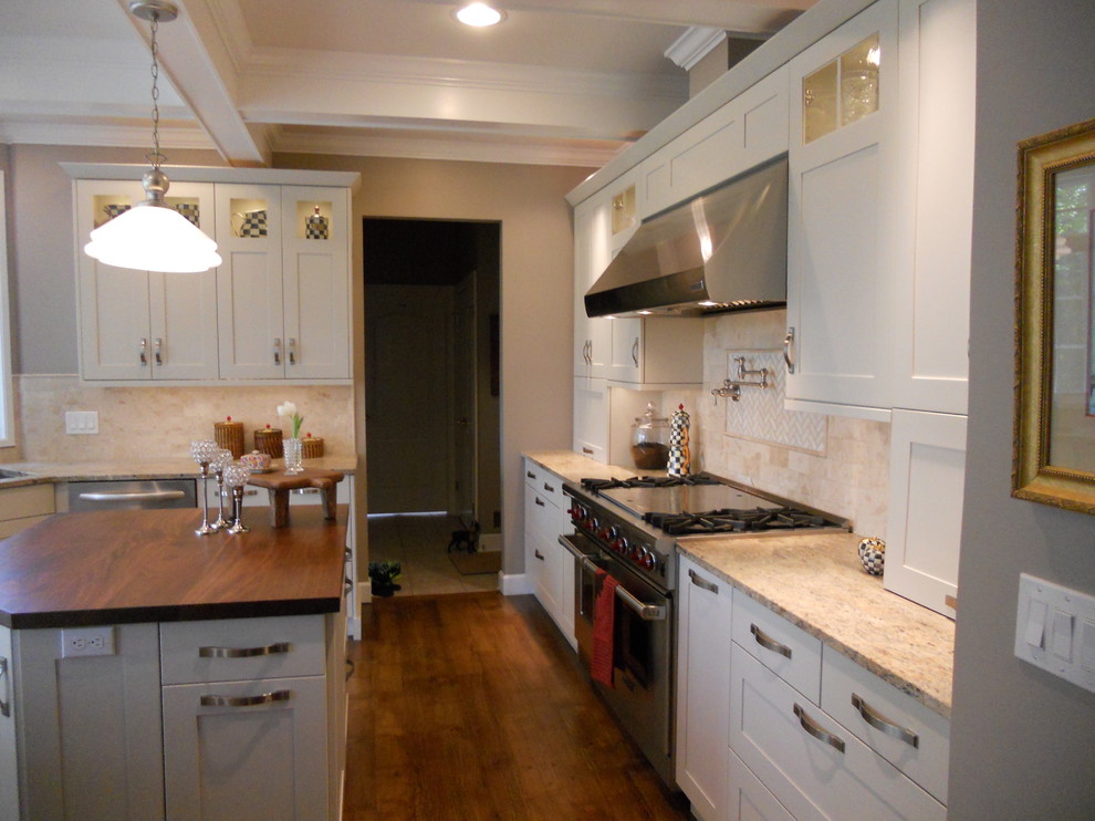 Large transitional u-shaped medium tone wood floor eat-in kitchen photo in New York with an undermount sink, recessed-panel cabinets, white cabinets, granite countertops, multicolored backsplash, porcelain backsplash, stainless steel appliances, gray walls and an island